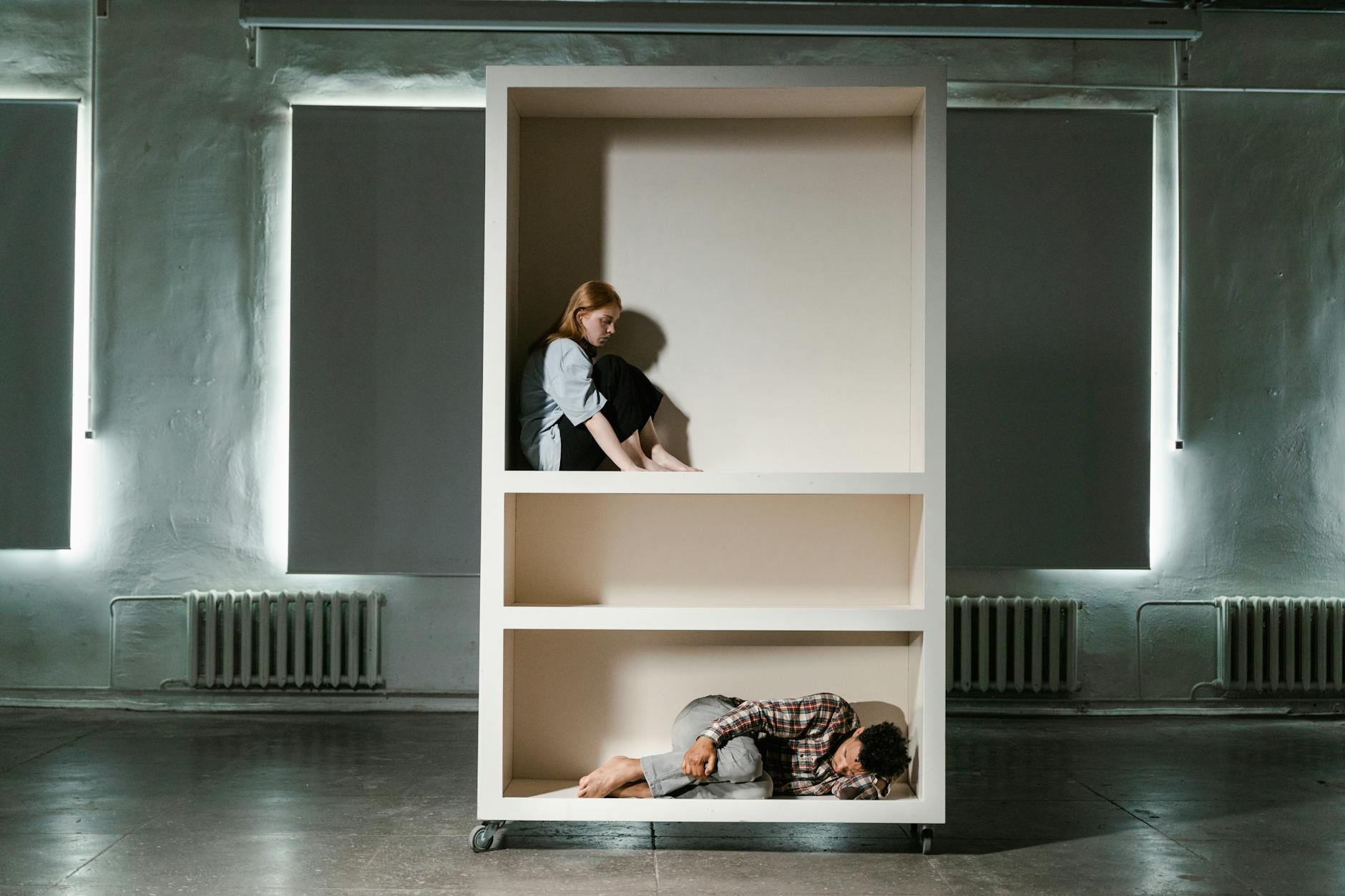a man and woman looking lonely in a cabinet
