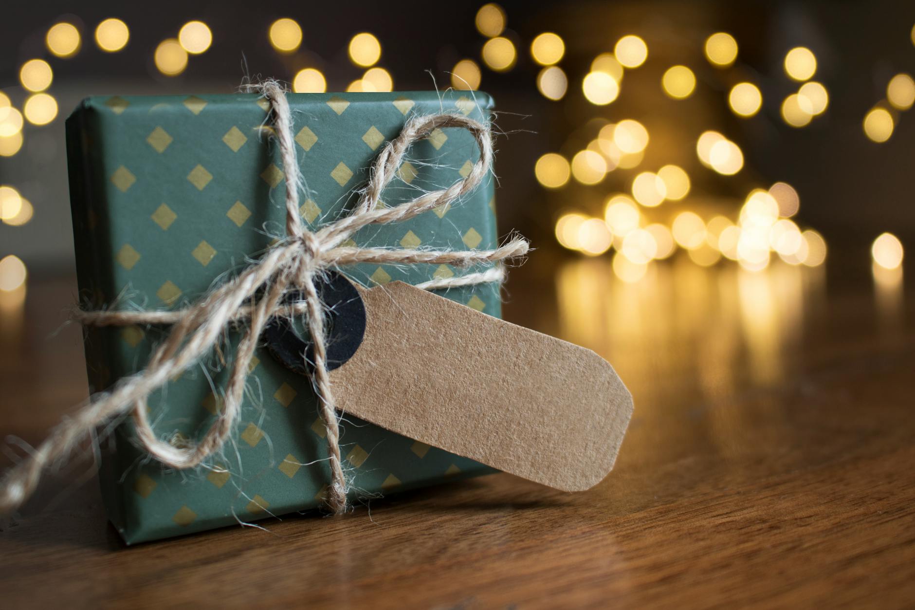 selective focus photography of gift box on brown wooden surface