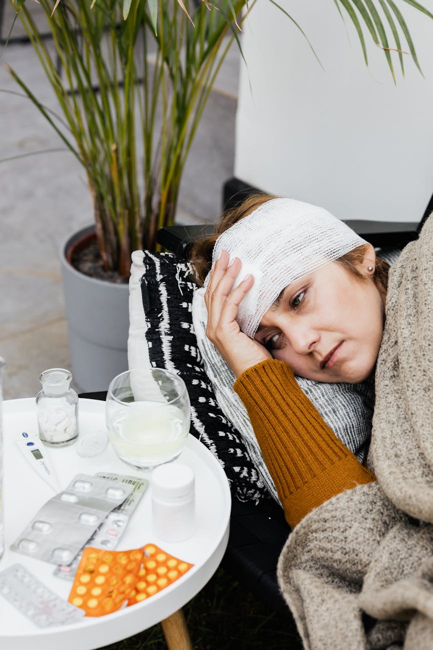 a woman with head bandage feeling sick