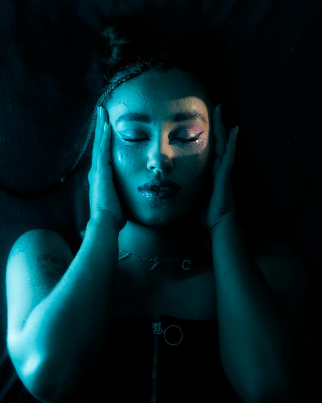 a woman holding her face while eyes closed
